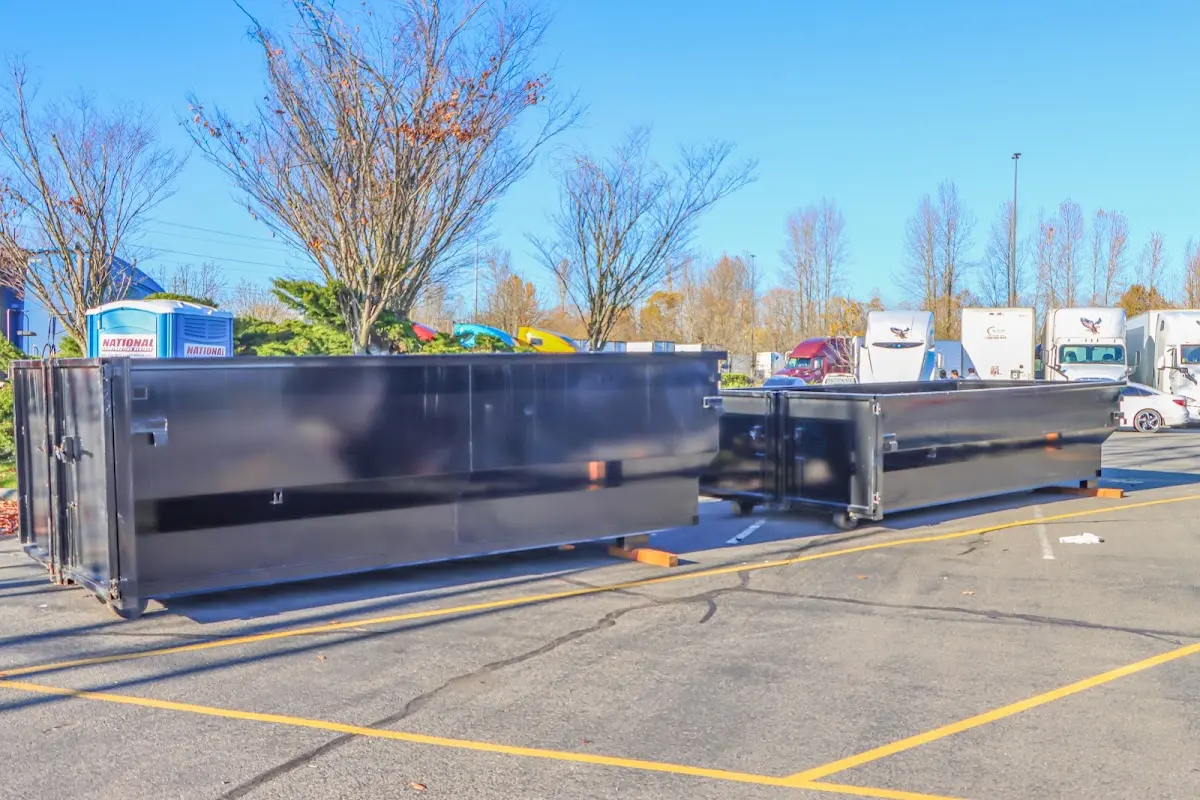 Professional dumpster rental service with roll-off container on residential driveway in Hot Springs